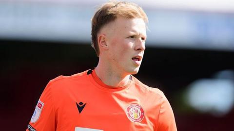 Filip Marschall in orange Stevenage goalkeeper kit