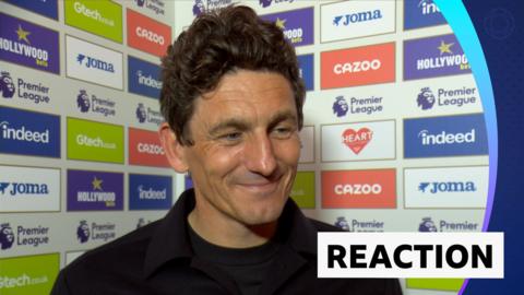 Brentford head coach Keith Andrews smiling during his post-match interview with BBC Sport