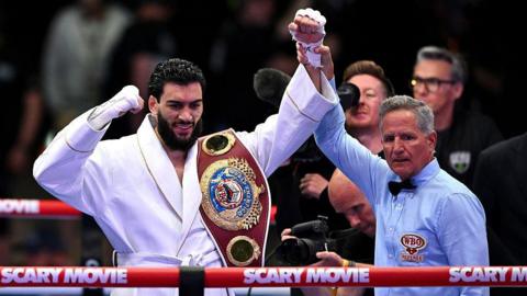 Hamzah Sheeraz is holding his world title with his hand in the air