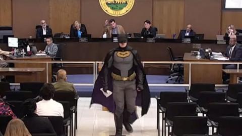 Watch: Man dressed as Batman tells city council to not assist ICE at Super Bowl