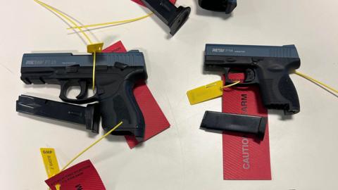 A photograph of two Turkish manufactured top-venting blank firing guns. The images shows two guns which have been converted to fire live ammunition.