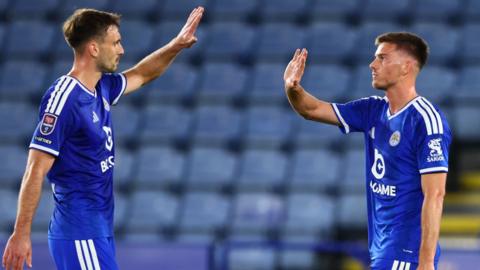 Admir Bristric high-fives Leicester teammate Luke Thomas after scoring against Fulham