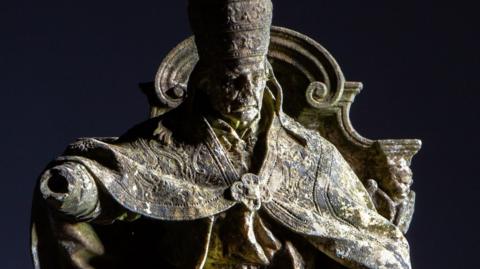Image of a marble sculpture of a Pope sitting on a throne