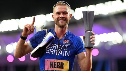 Josh Kerr celebrates while holding the 1500m trophy after winning the inaugural World Athletics Ultimate Champion event in Budapest, Hungary