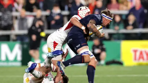 Edinburgh’s Glen Young tackled by Jack Murphy and Ben Carson of Ulster
