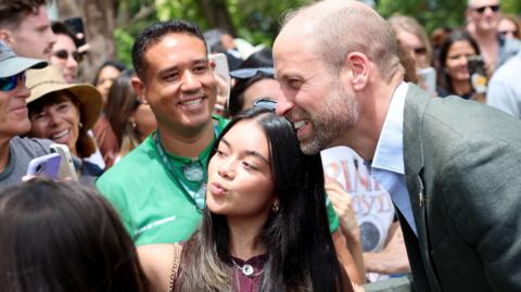Prince William and a woman taking a selfie