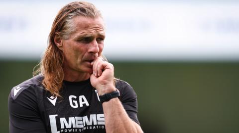 Gillingham boss Gareth Ainsworth watches his players train 