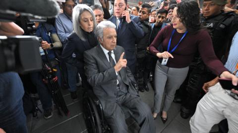 Lenin Moreno leaves the National Court of Justice during a corruption case in Quito.