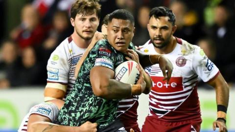 Leigh Leopards and Wigan Warriors face off in a Super League match