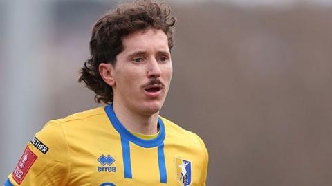 Aaron Lewis in action for Mansfield Town last season  