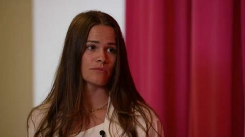  Brittany Bee is seen talking with a reporter. 