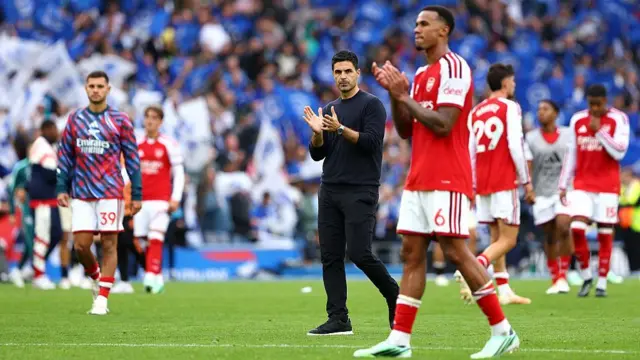 Mikel Arteta applauds the fans