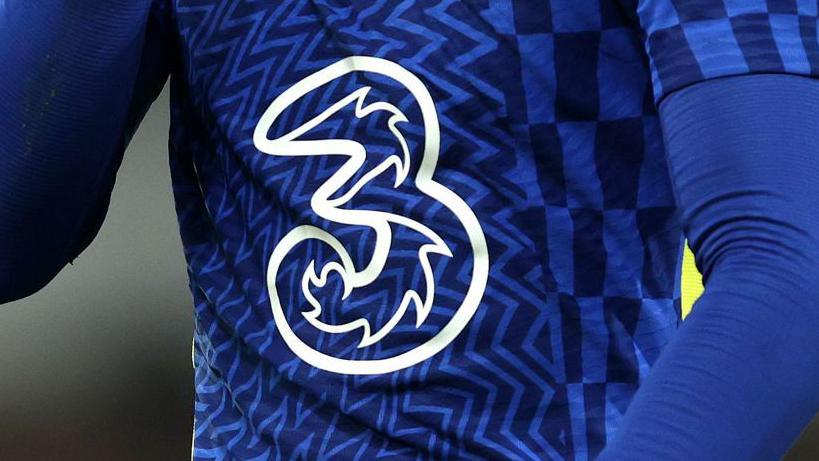 A detailed view of the Three logo is seen on the shirt of a Chelsea player during the Premier League match in 2022