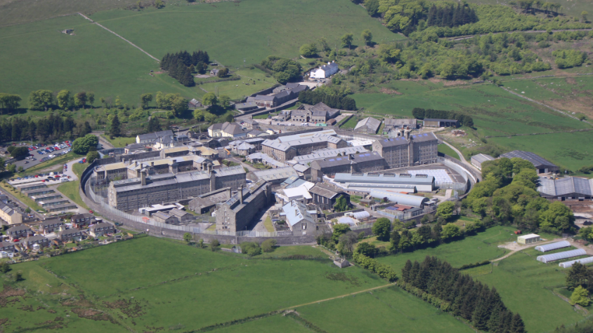An aerial shot of Dartmoor Prison showing a number of buildings within a fenced off area