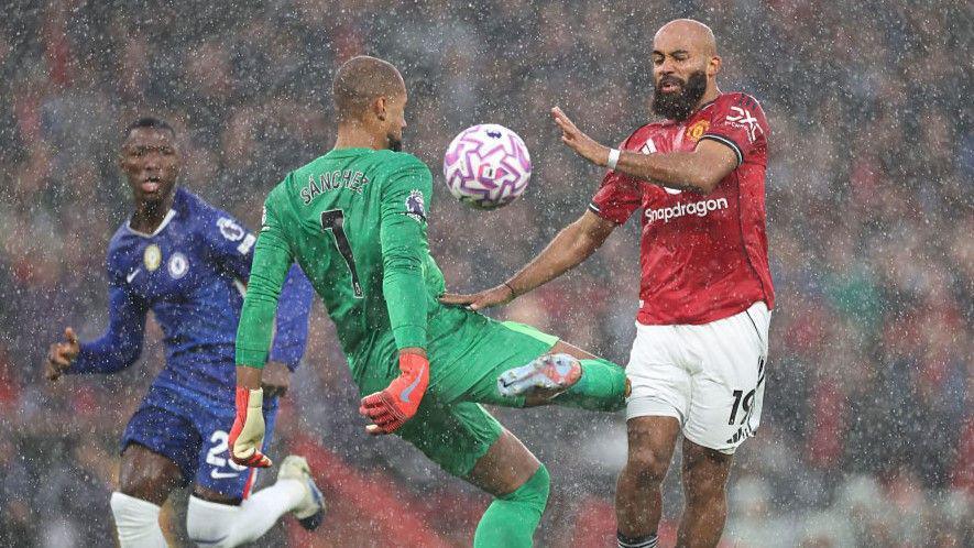 Chelsea goalkeeper Robert Sanchez brings down Manchester United's Bryan Mbeumo in the first half at Old Trafford