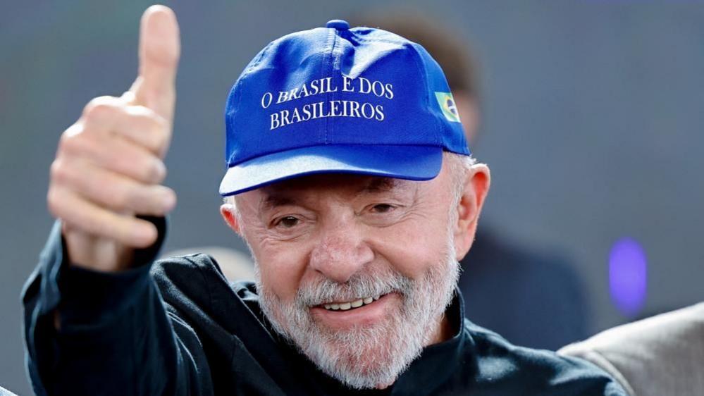 Brazilian President Luiz Inacio Lula da Silva wears a blue hat.