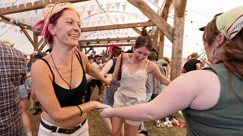 Three women dancing at the Country Music Festival at Tooting Common, London (Credit: Getty Images)
