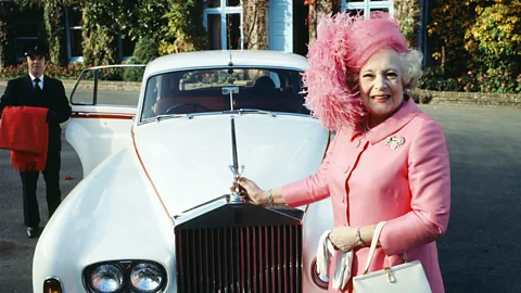 Barbara wears an all pink outfit and smiles at the camera while stood in front of a white car (Credit: Getty Images)