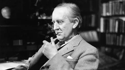A black-and-white photograph of JRR Tolkien smoking a pipe (Credit: Alamy)