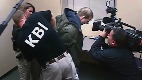 A still officers apprehending a man while being filmed by a film crew in To Catch a Predator from the documentary Predators (Credit: Sweet Relief Productions/ Rosewater Pictures)