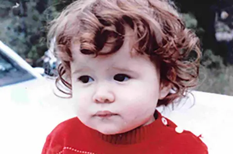Christa Pike Christa Pike as a toddler. She has brown, short curly hair and is wearing a red jumper. The background appears to show part of a white vehicle