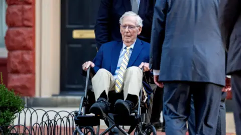 Mitch McConnell is seen in a wheelchair.