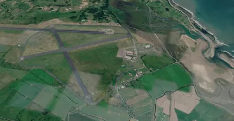 The Former Llanbedr Airfield Site, fields and the river are visible.