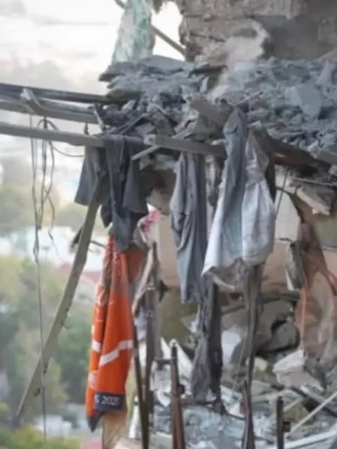 Dayana Yastremska / Facebook An orange clay Roland Garros towel with the year 2025 seen on it hangs from the wreckage of a damaged multi-storey residential building in Odesa, southern Ukraine, following a Russian aerial attack. Photo: 12 September 2026