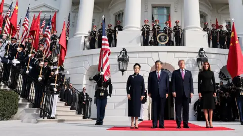 President Xi and President Trump outside the White House with guards in uniform and and flags 
