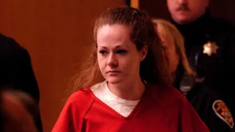 Christa Pike appears in court in 2007 wearing an orange prison shirt