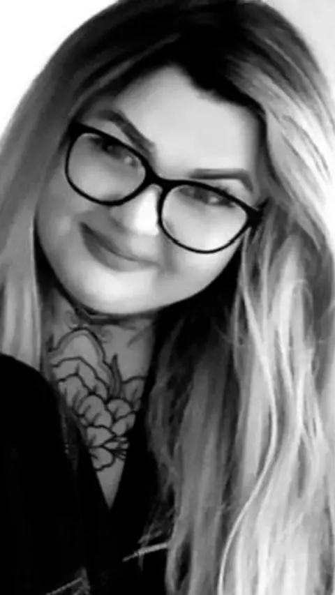 Black and white image of woman with long light hair and glasses