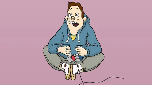 Svenni Freese sitzt alleine auf dem Boden und hält einen Spielecontroller in der Hand.