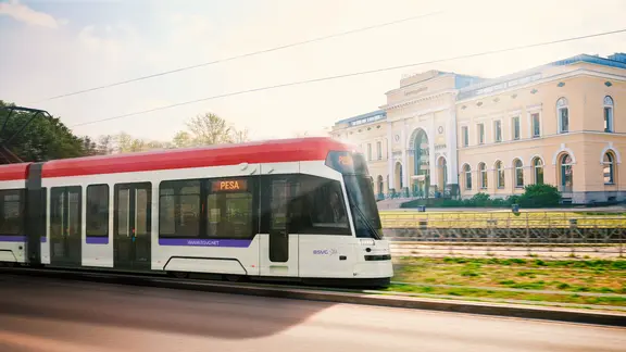 Zeichnung einer fahrenden, modernen, weißen Stadtbahn mit rotem Dach