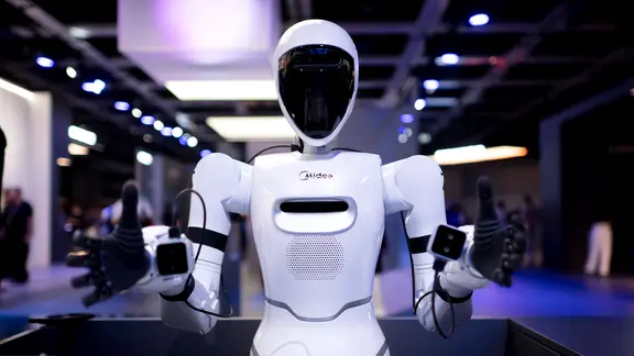 Ein weißer Roboter wird auf einer Messe vorgestellt.