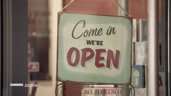 Schild mit der Aufschrift " Come in we're open".
