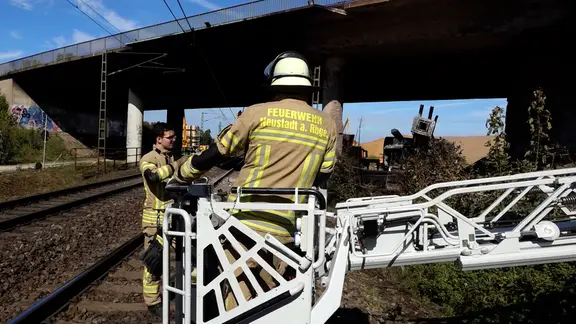 Ein ausgebrannter LKW neben Gleisen in Neustadt unter Brücken.