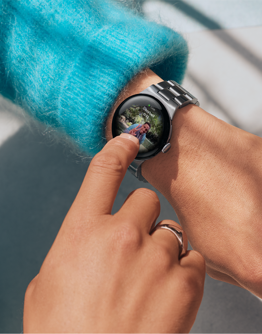 Image of woman using Pixel Watch to see Nest Doorbell live feed