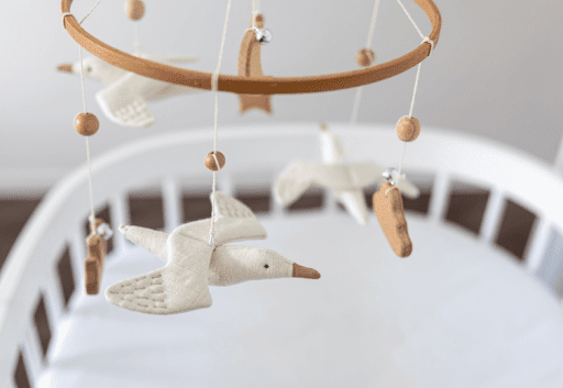 baby mobile above a crib with a swan on it