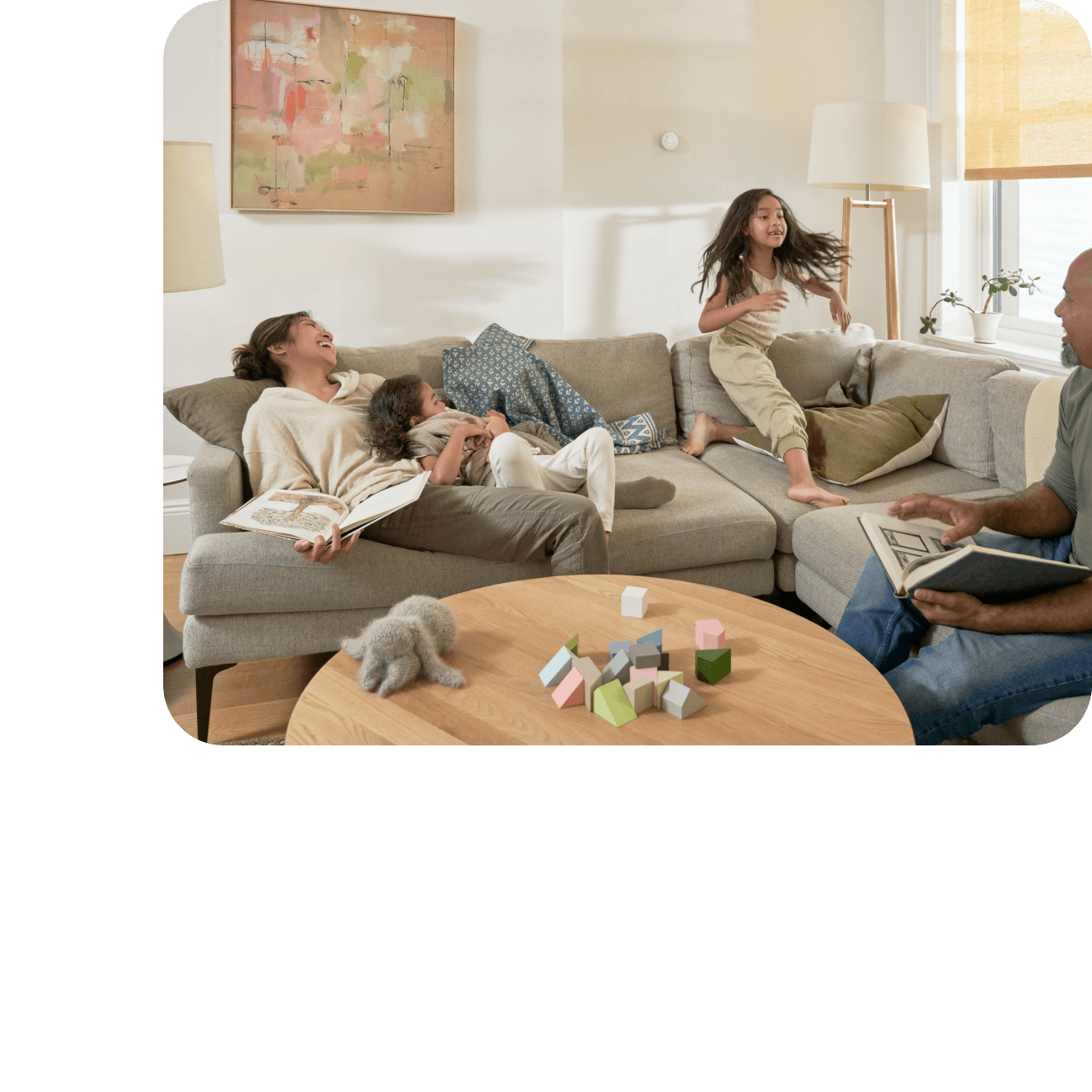 family sitting on living room couch laughing together