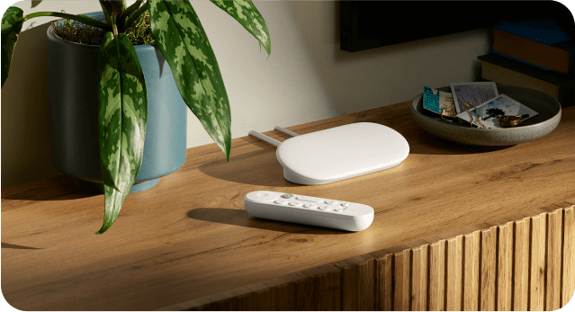 Image of Google TV Streamer and remote in a living room