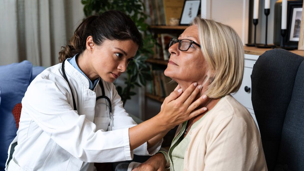 Doctor checking a female's neck
