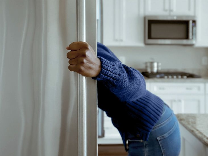 woman looking in a refrigerator