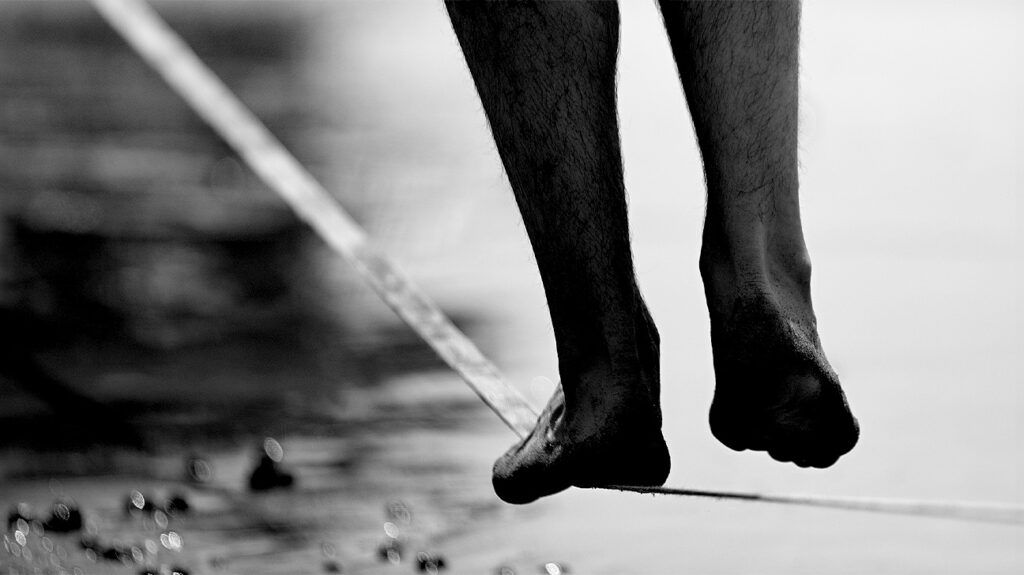 A person walking along a tightrope to represent debilitating anxiety.