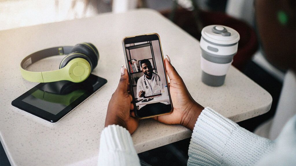 adult black woman on a video call with her doctor