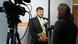 A visitor to the DW Global Media Forum in Bonn during camera training at the DW Akademie stand.