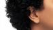 close up of african american woman's ear over white background