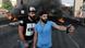 Two protesters take a selfie in front of a burning street barricade in Beirut. 