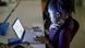 A young woman works focused at her computer.