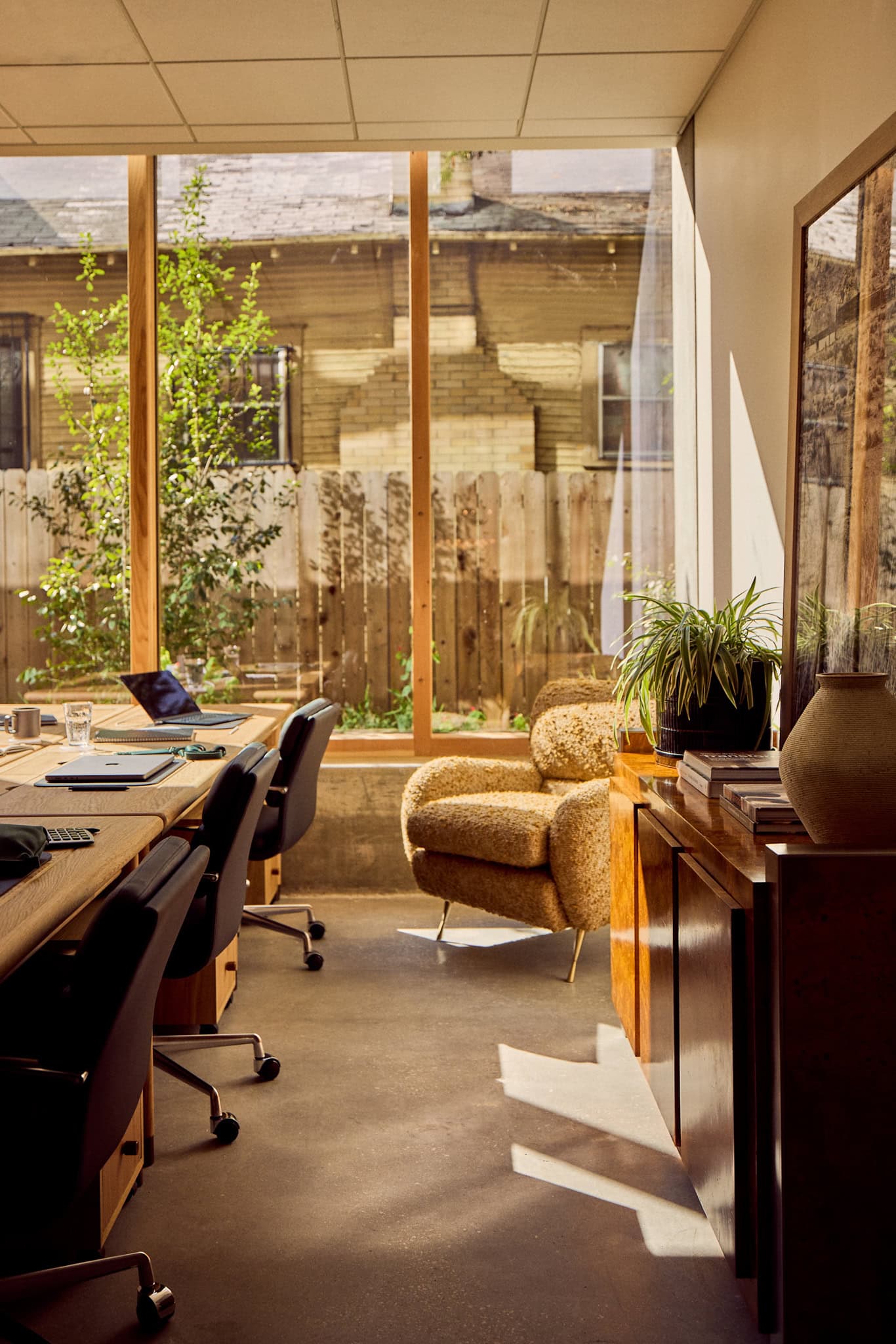 Sunlit private office with lounge chair and desk at The Malin East Austin