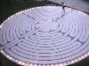 rhi: A candle-lit labyrinth with a person just entering. (Default)